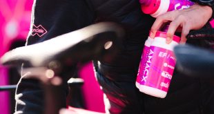 Amacx Nutrition bottles in person's hands near bike saddle