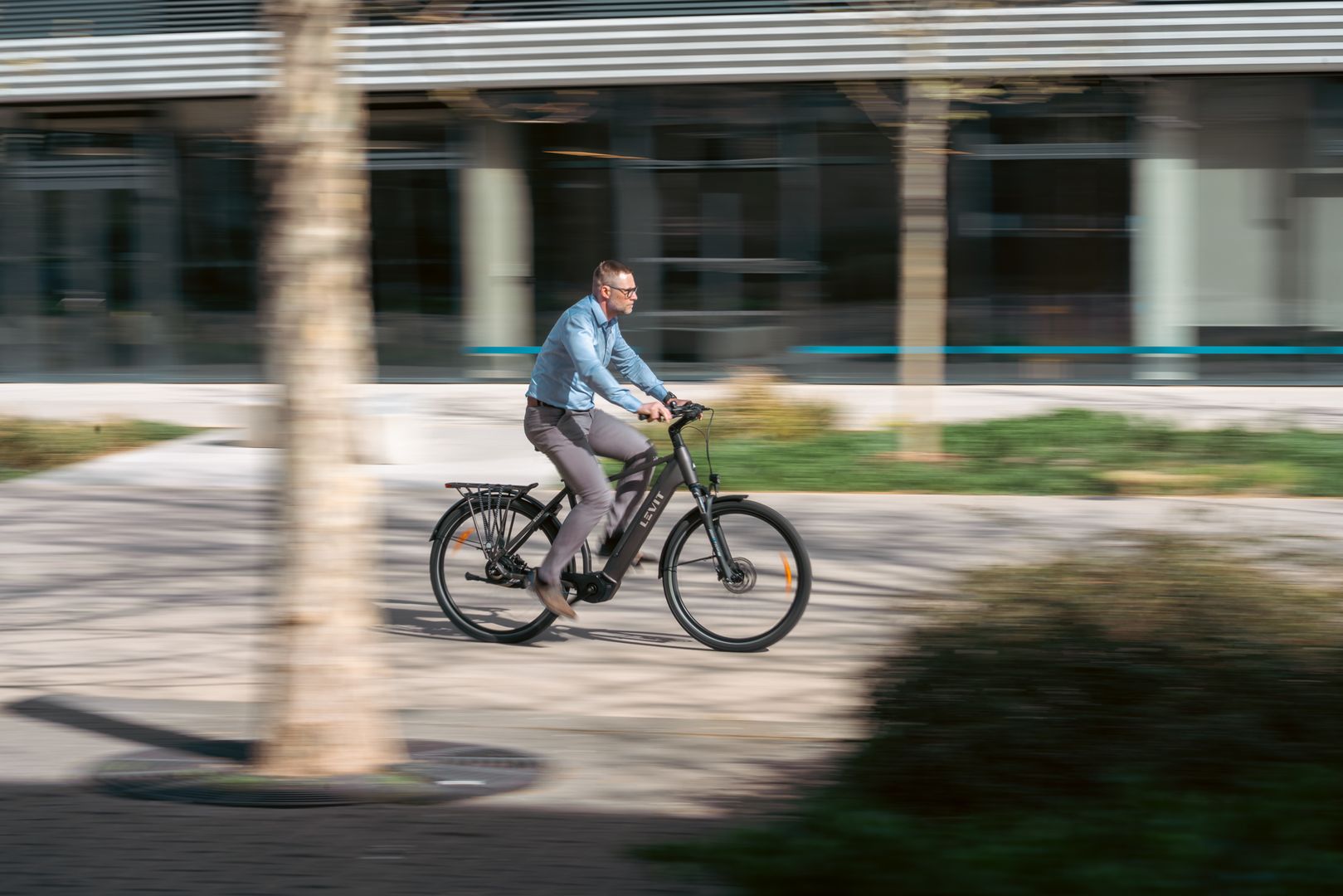 Levit bike man riding through urban environment