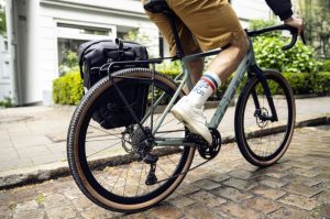Ortlieb Thru Axle and rack fitted to bike being ridden Ortlieb introduces Thru Axle based rack mounting system