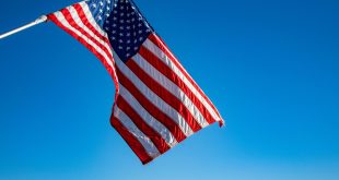 US Flag against blue sky