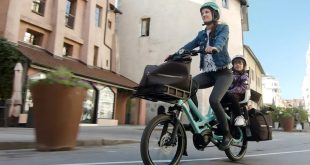 Woman on a tern bicycle with child